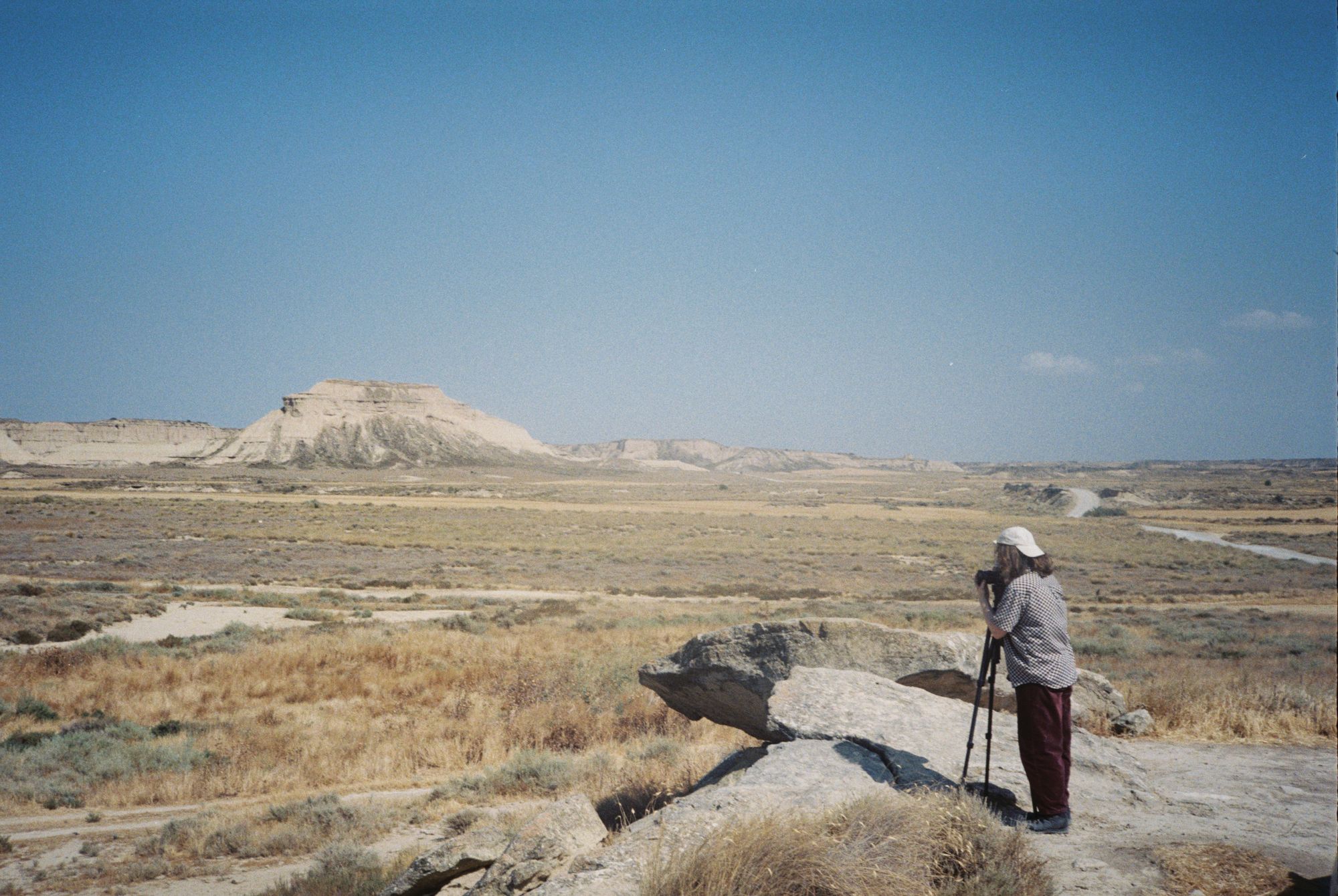 A photo of Raina taking photos in the Bardenas, Spain, taken by their partner Fien van der Kaaij